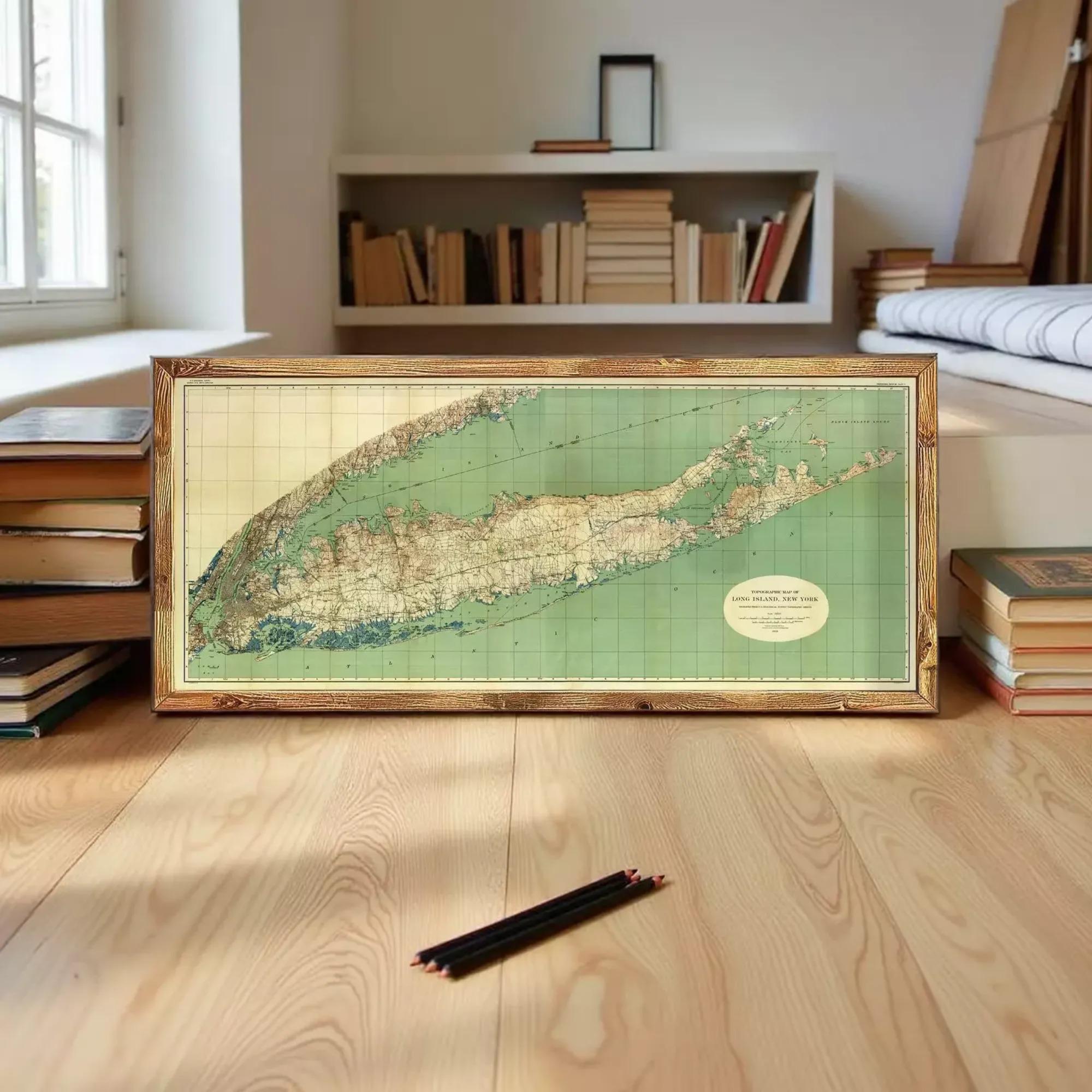 A framed map of the island of New Jersey is displayed on a wooden floor, surrounded by books and other items.