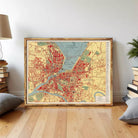 The image is a framed vintage map of a city, depicting the layout and streets of the area.