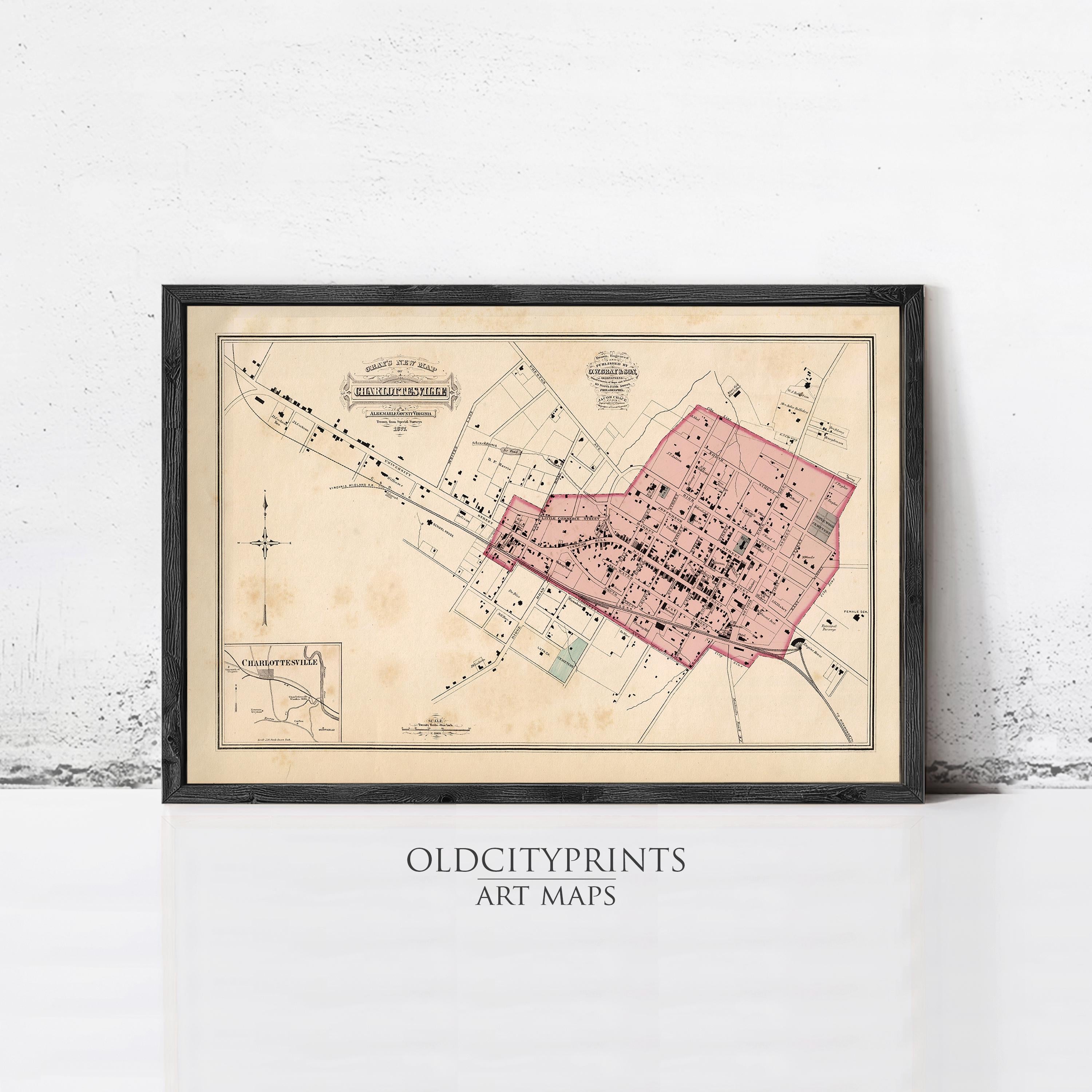 The image is a framed vintage map of a city, likely from the 19th century, with a pink color scheme.