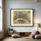 The image is a framed vintage map of a city, depicting a detailed layout of streets, buildings, and other urban features.