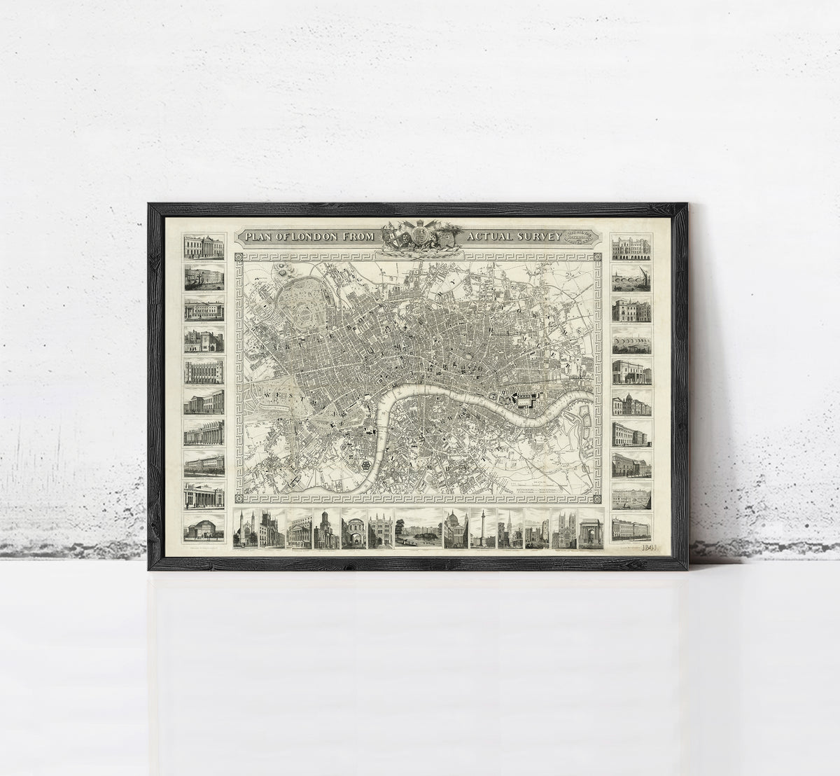 The image is a framed vintage map of London, England, featuring a detailed illustration of the city's streets, landmarks, and surrounding areas.