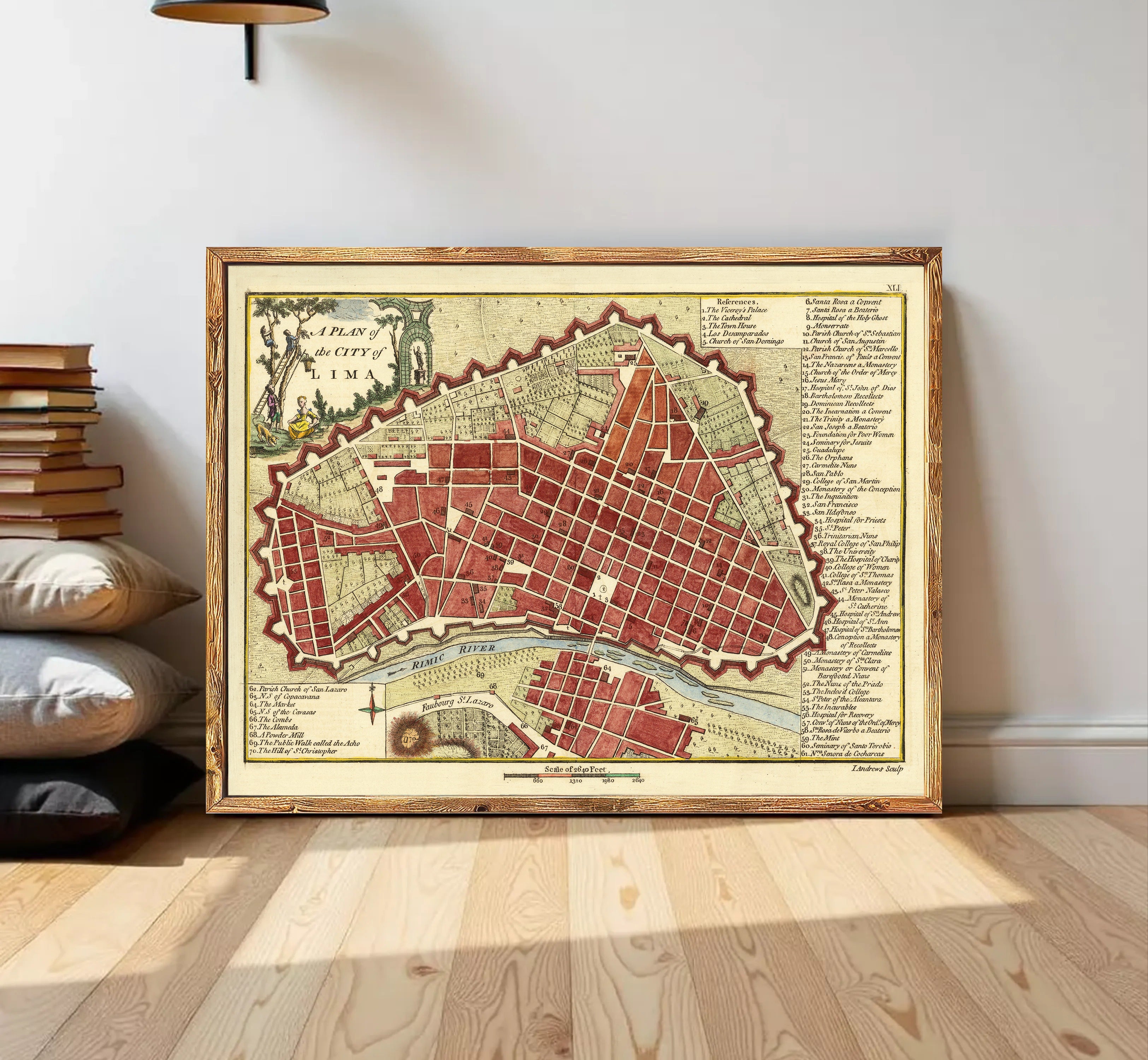 The image is a framed map of a city, likely L'Aquila, with a detailed layout and various landmarks and streets.
