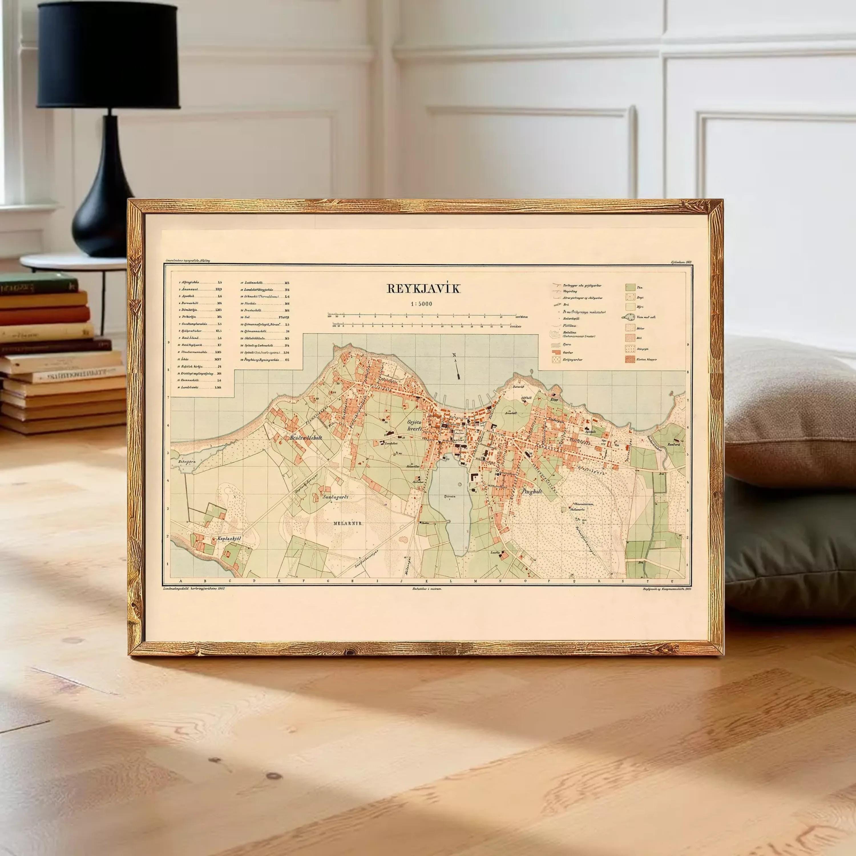 a framed map of Reykjavik, Iceland, with a wooden frame and a vintage-style map design.