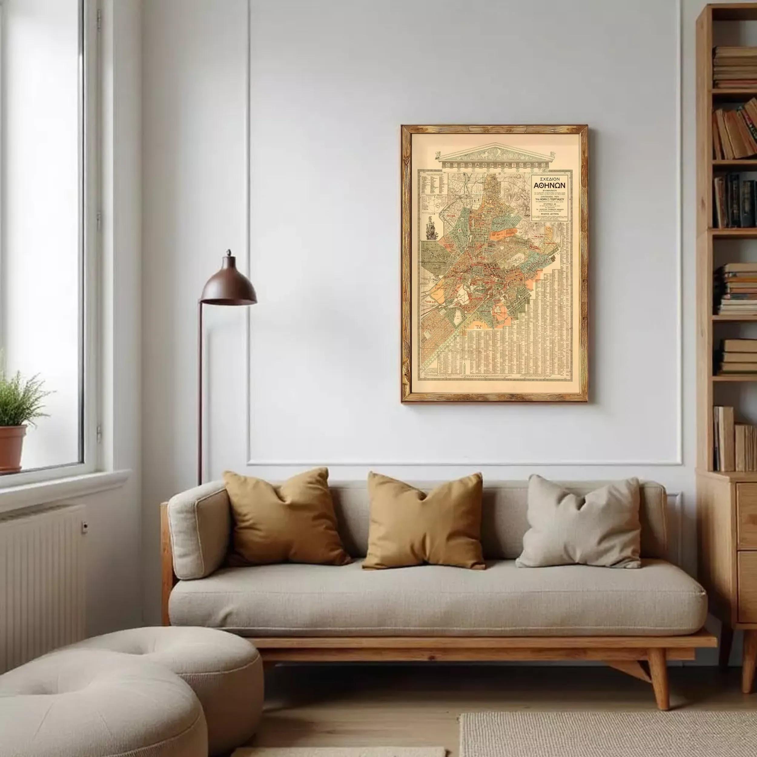 a cozy living room with a large framed map of the city hanging on the wall above a beige sofa with three pillows.