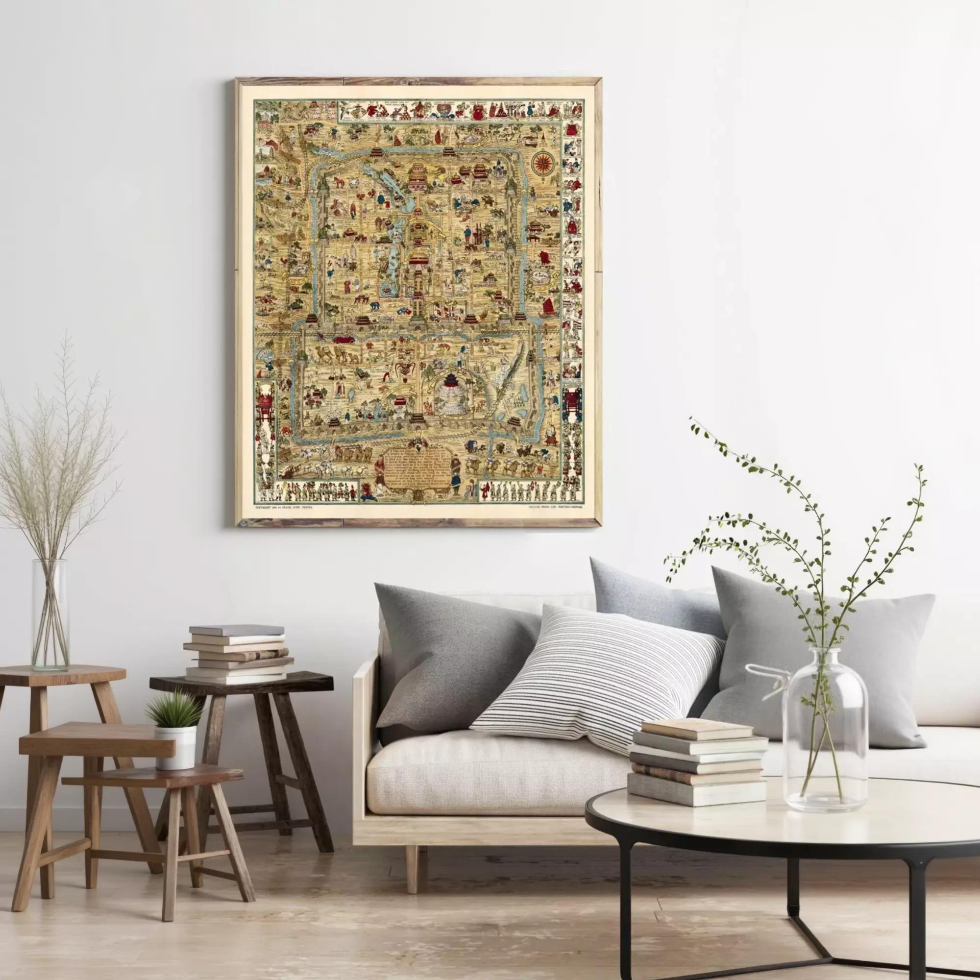 a living room with a large, ornate map hanging on the wall above a couch with pillows. The room has a wooden coffee table, a side table, and a vase with flowers. There are also several books and decorative items on the coffee table and side table.