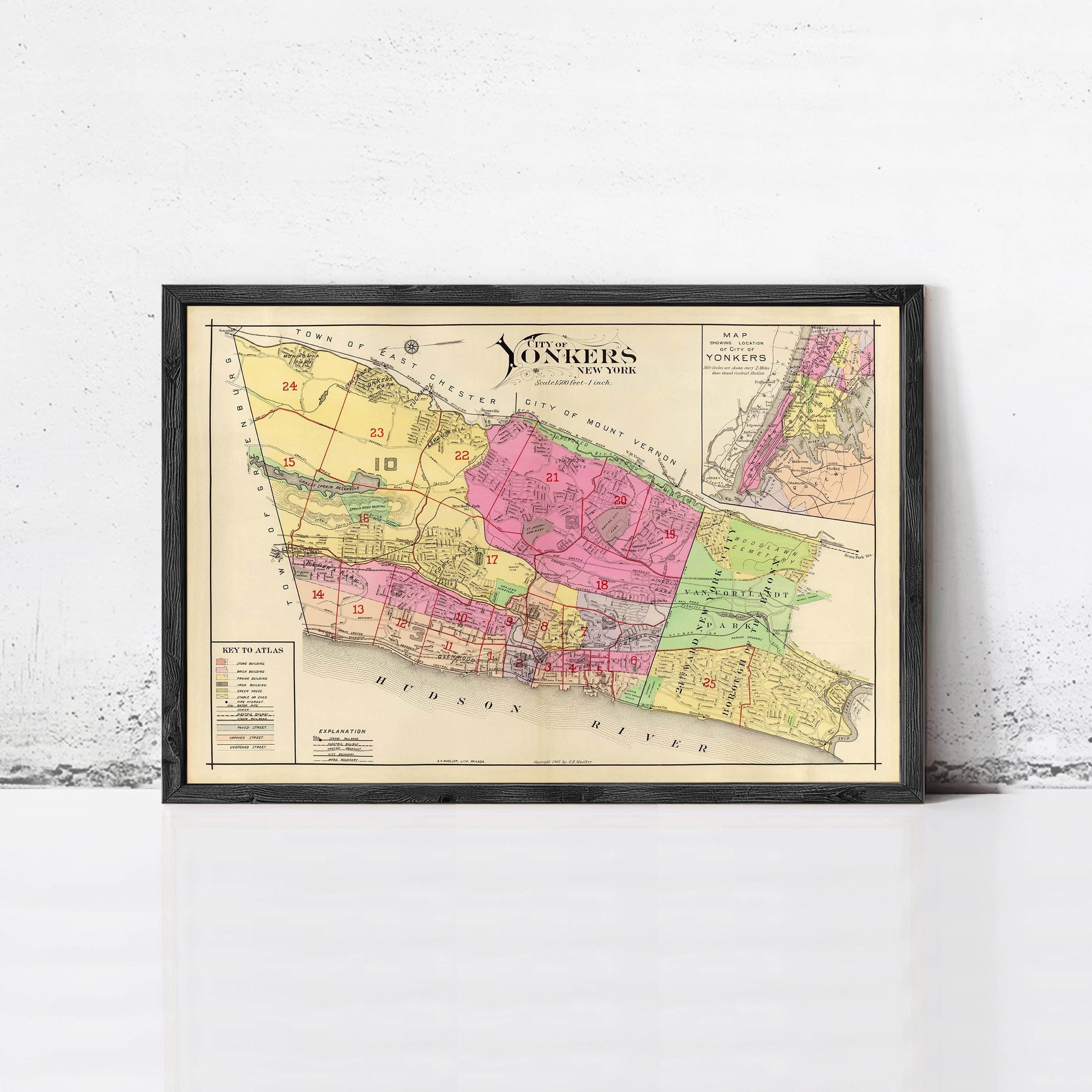 The image is a framed vintage map of New York, depicting the city in a colorful and detailed manner.