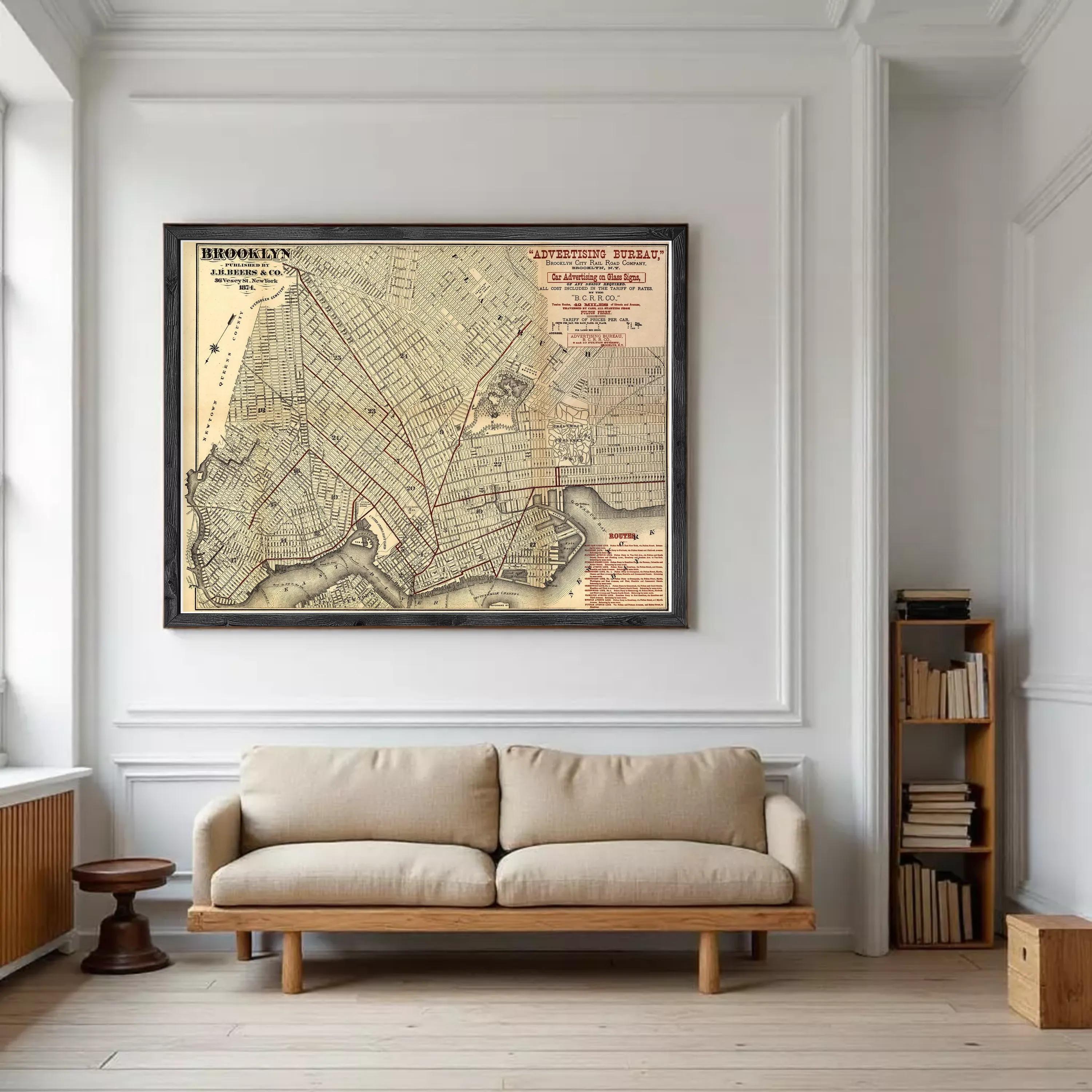 a large framed map of New York City hanging on a white wall in a living room.