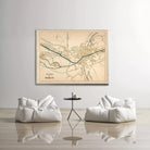 a large map of a town or city displayed on a wall, with two white bean bag chairs positioned in front of it.