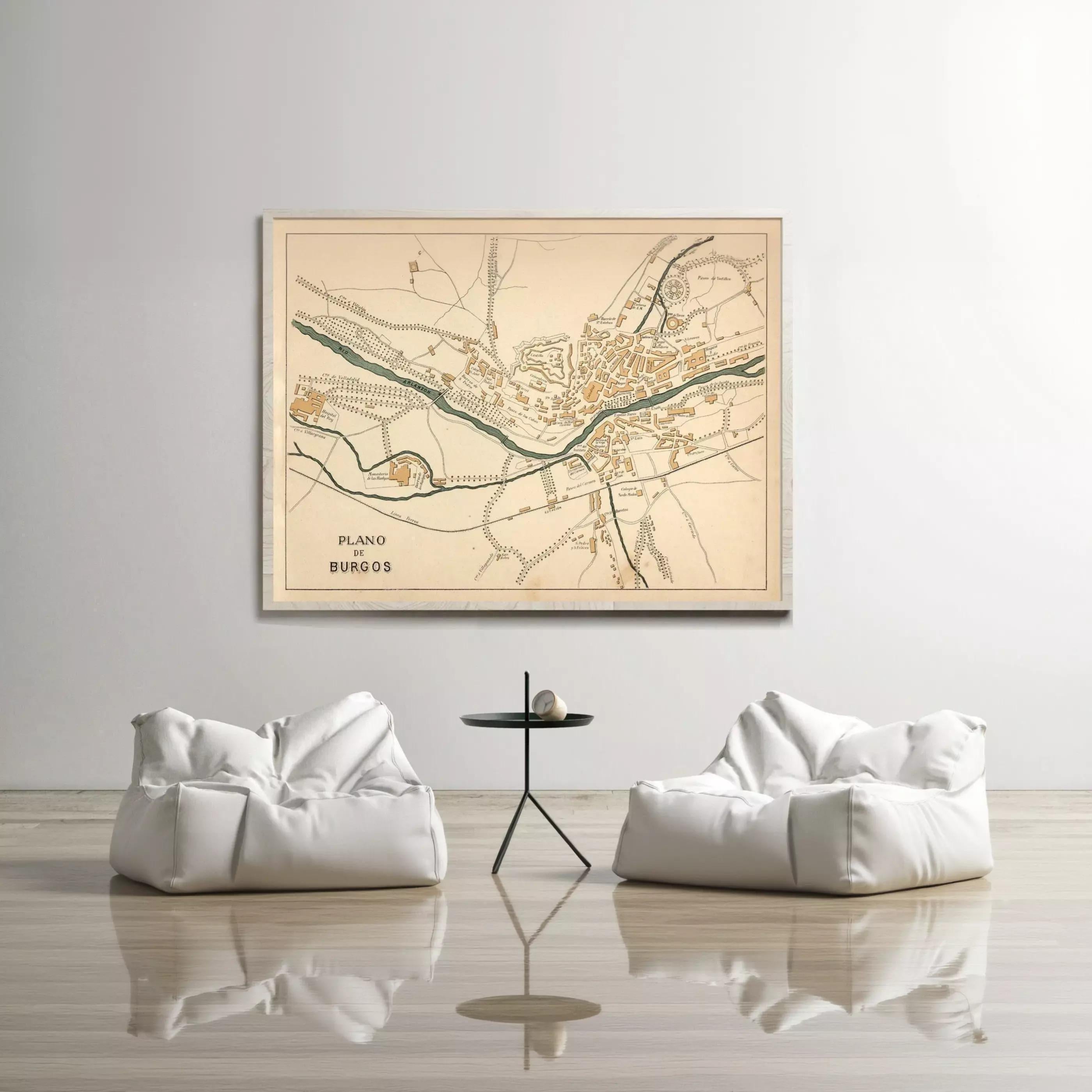 a large map of a town or city displayed on a wall, with two white bean bag chairs positioned in front of it.