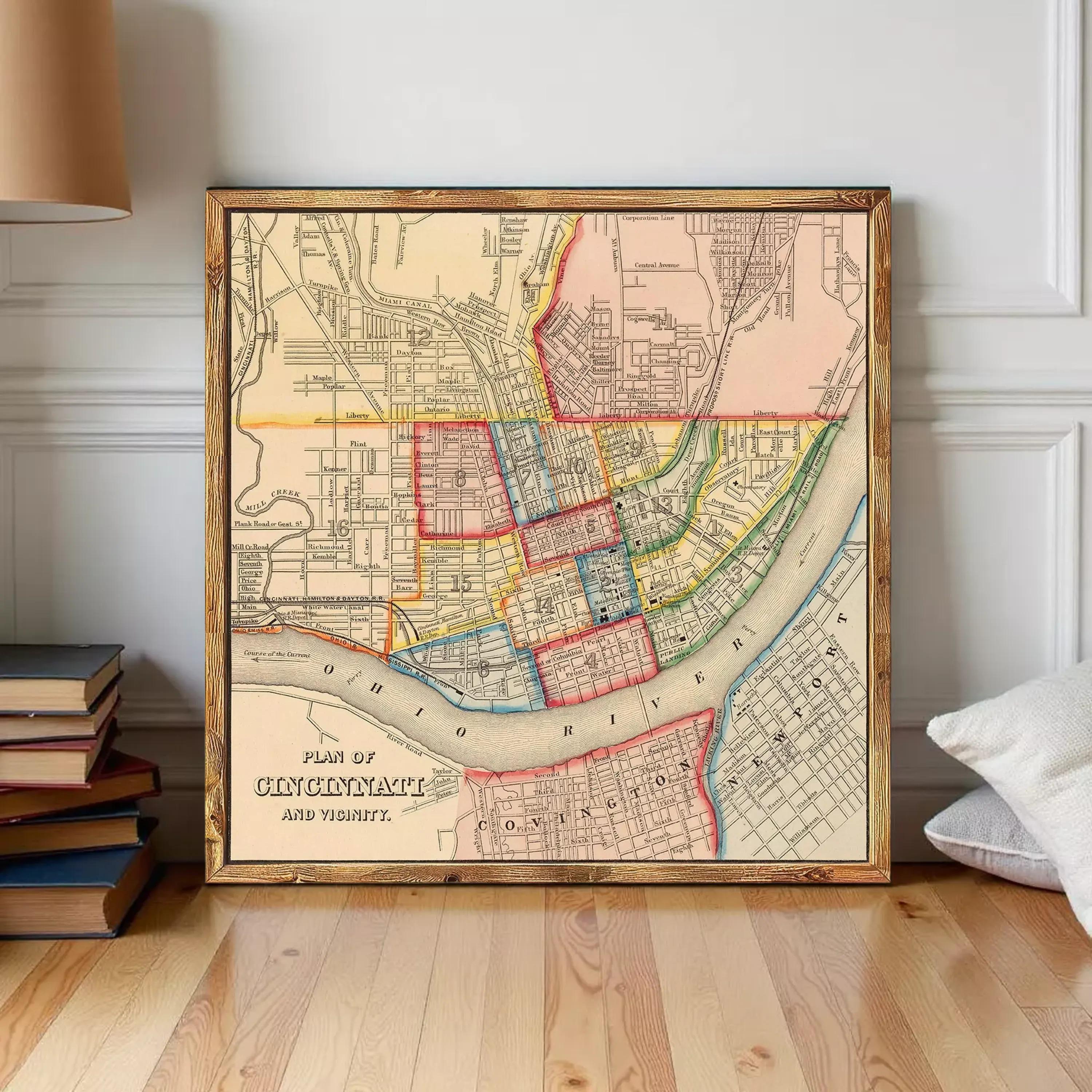 A framed vintage map of Cincinnati, Ohio, depicting the city's layout and surrounding areas.