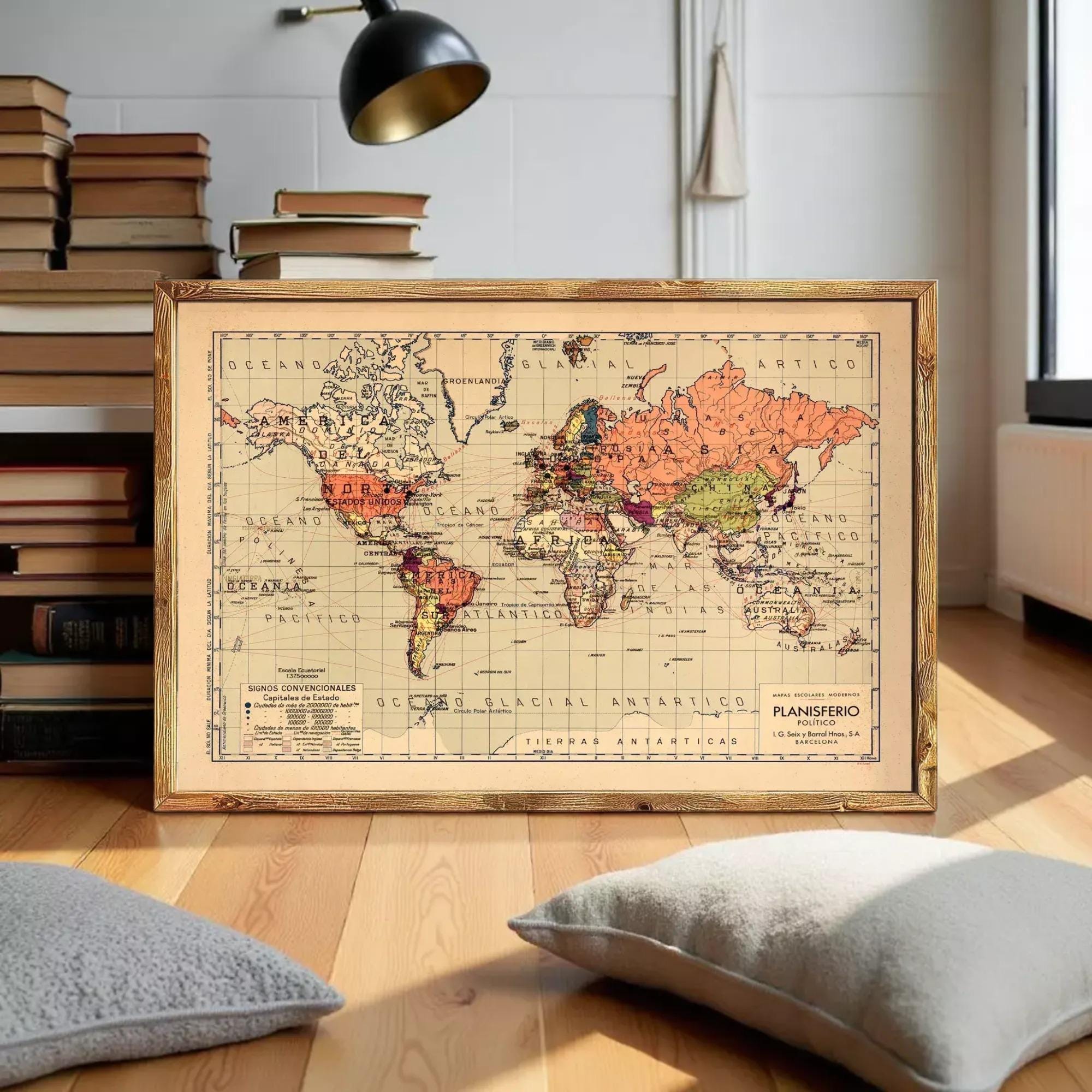 The image is a framed vintage world map depicting the continents and oceans in a color palette of orange, pink, and green.