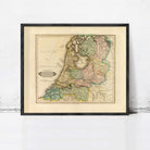The image is a framed map of the Netherlands, depicting the country's geographical layout and boundaries.