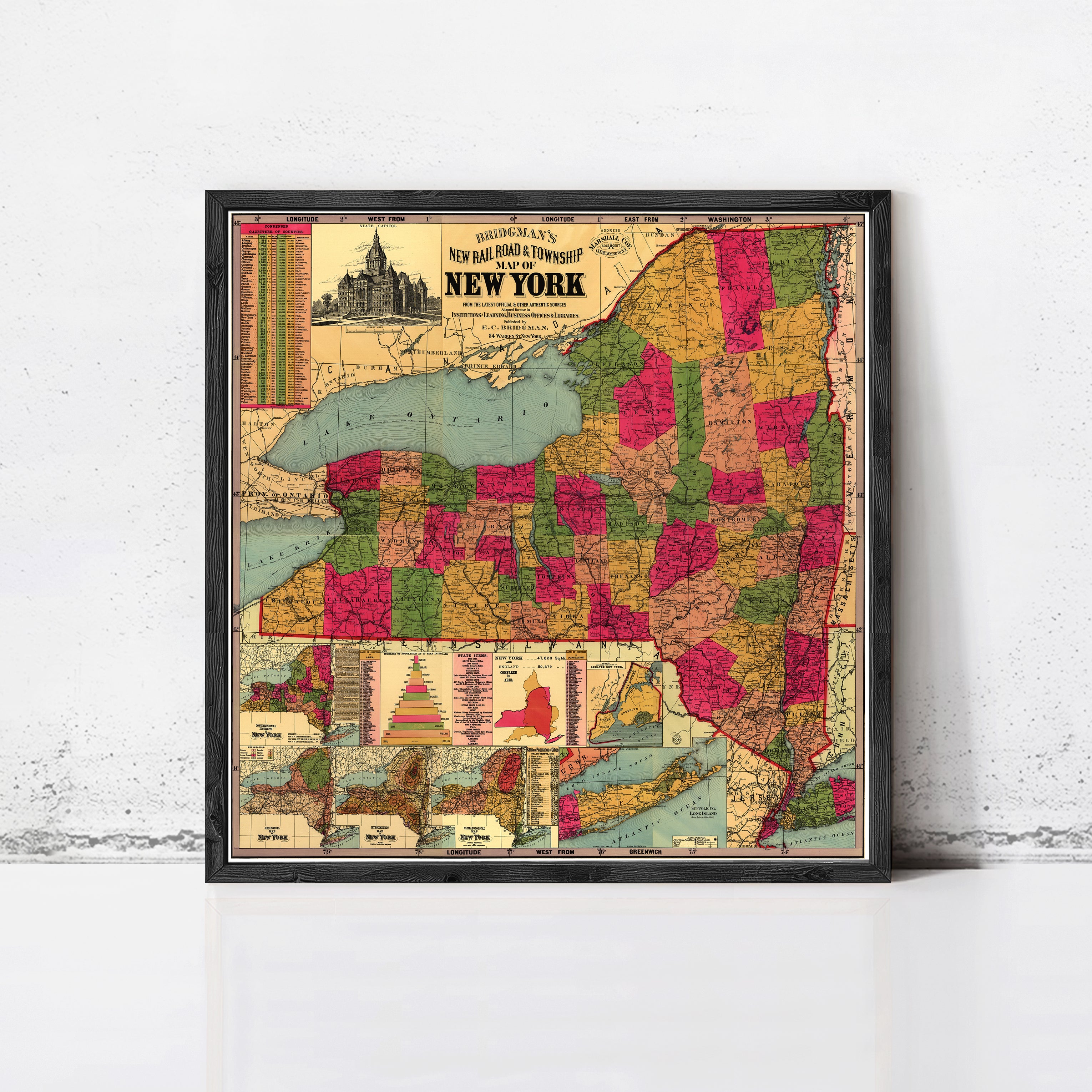 A framed vintage map of New York, depicting the state in a colorful and detailed manner.