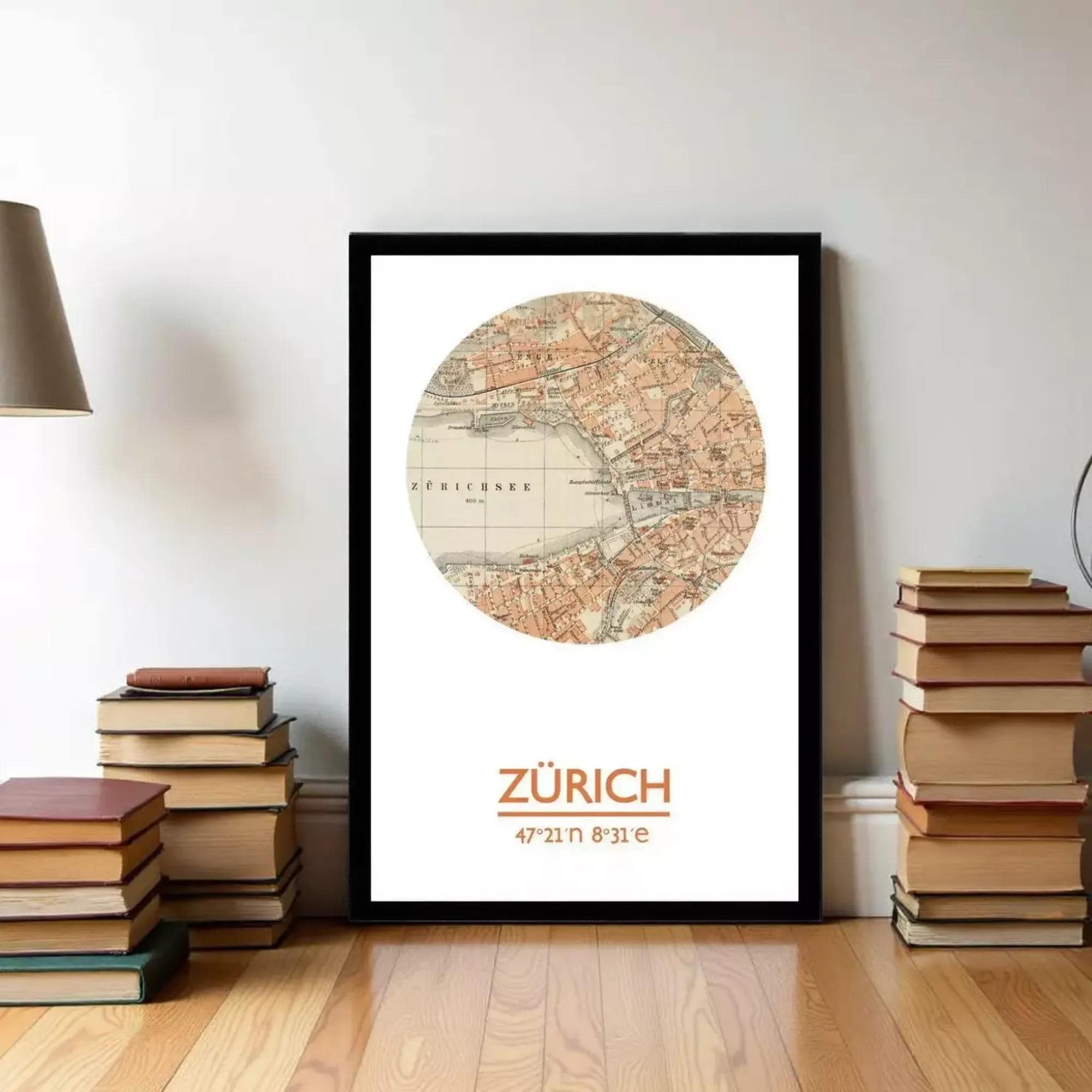 A framed map of Zurich, Switzerland, with a stack of books and a lamp in the background.