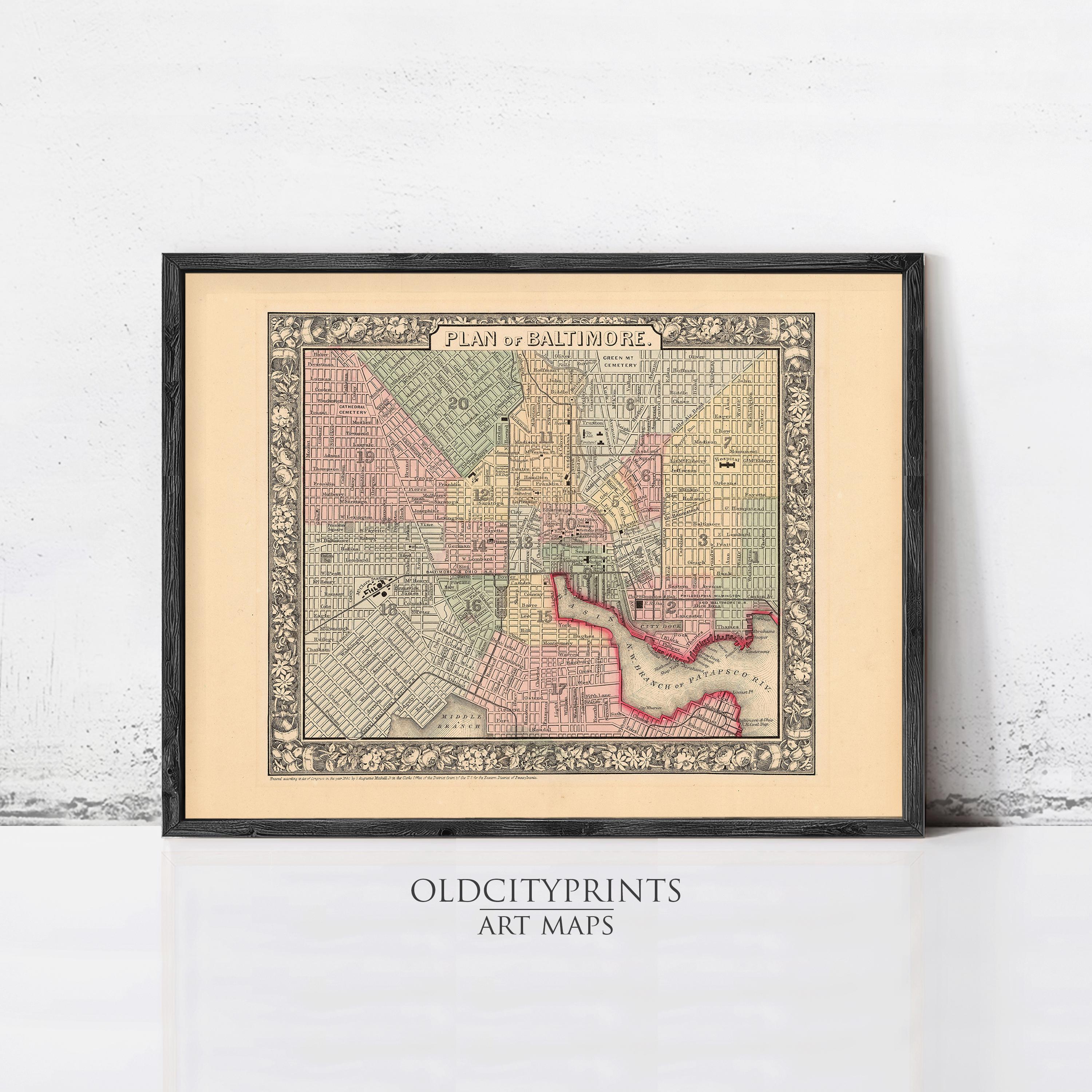 The image is a framed vintage map of Baltimore, Maryland, with a black border and a beige background.
