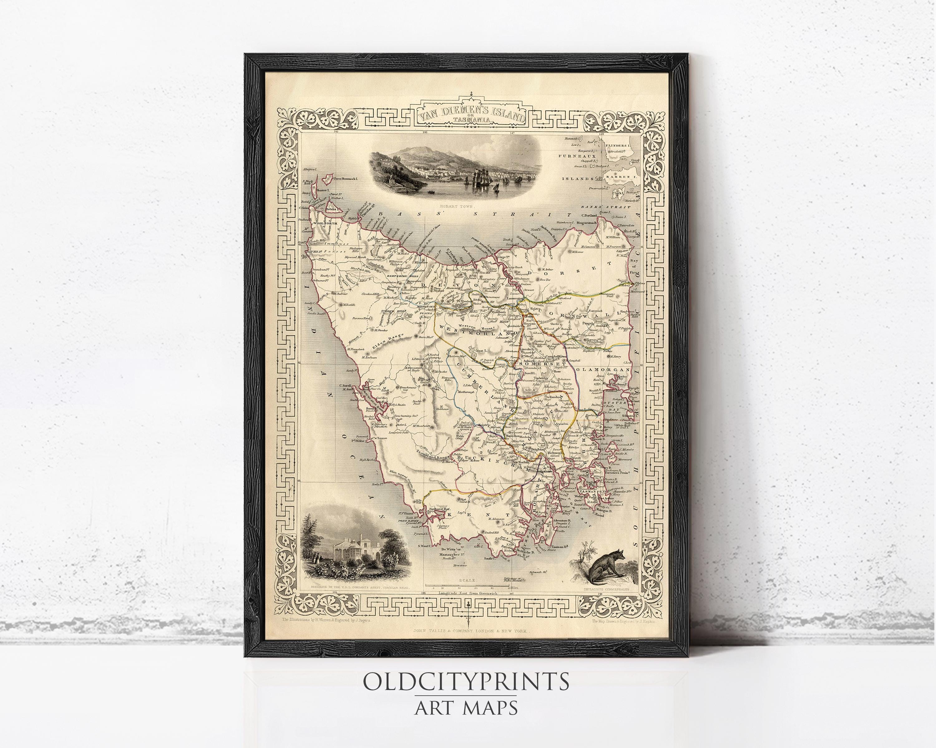 The image is a framed antique map of the State of Victoria, Australia, with various illustrations and details surrounding the map.
