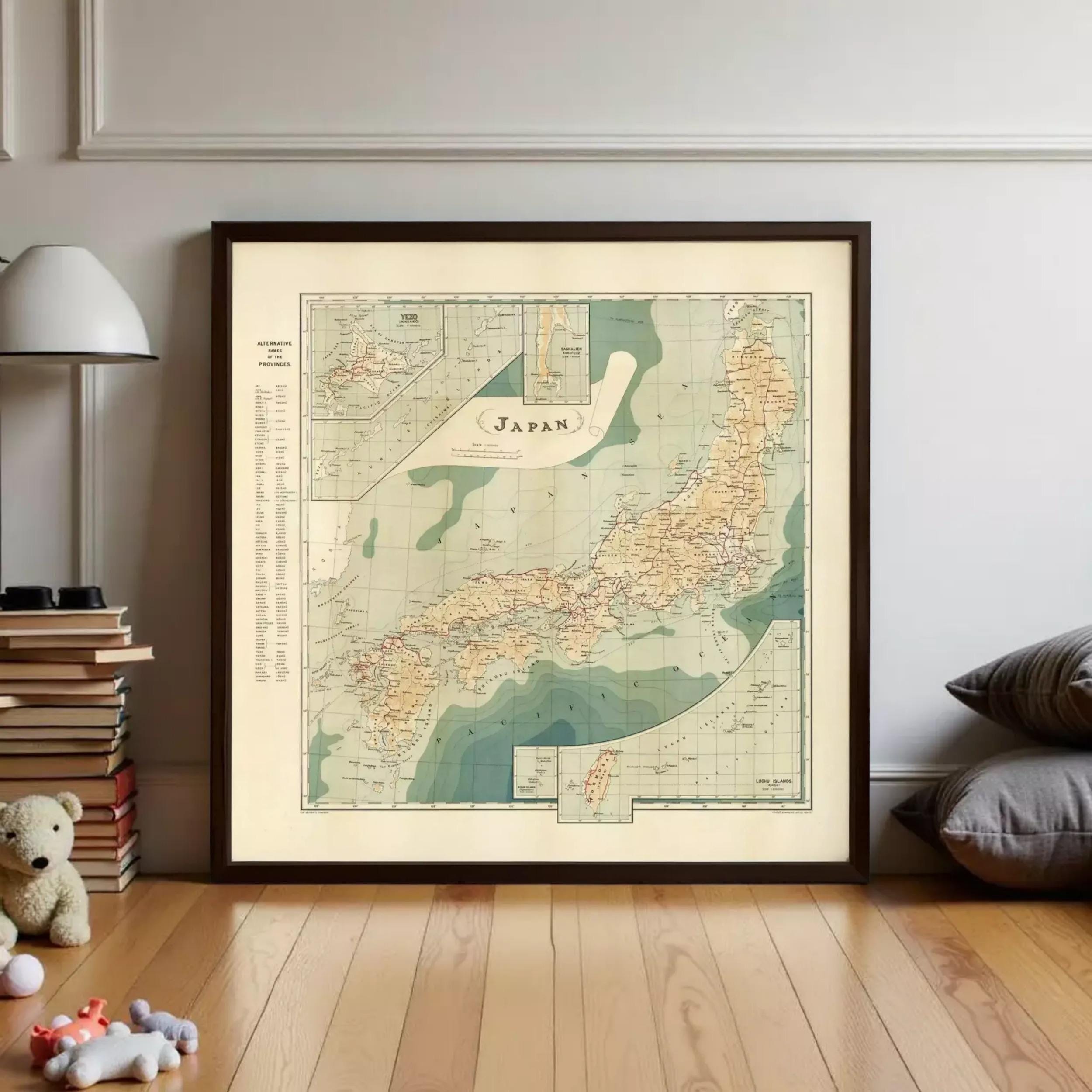 a framed vintage map of Japan, with a teddy bear and books visible in the background.