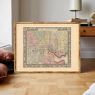 The image is a framed antique map of Baltimore, Maryland, depicting the city's streets and neighborhoods.
