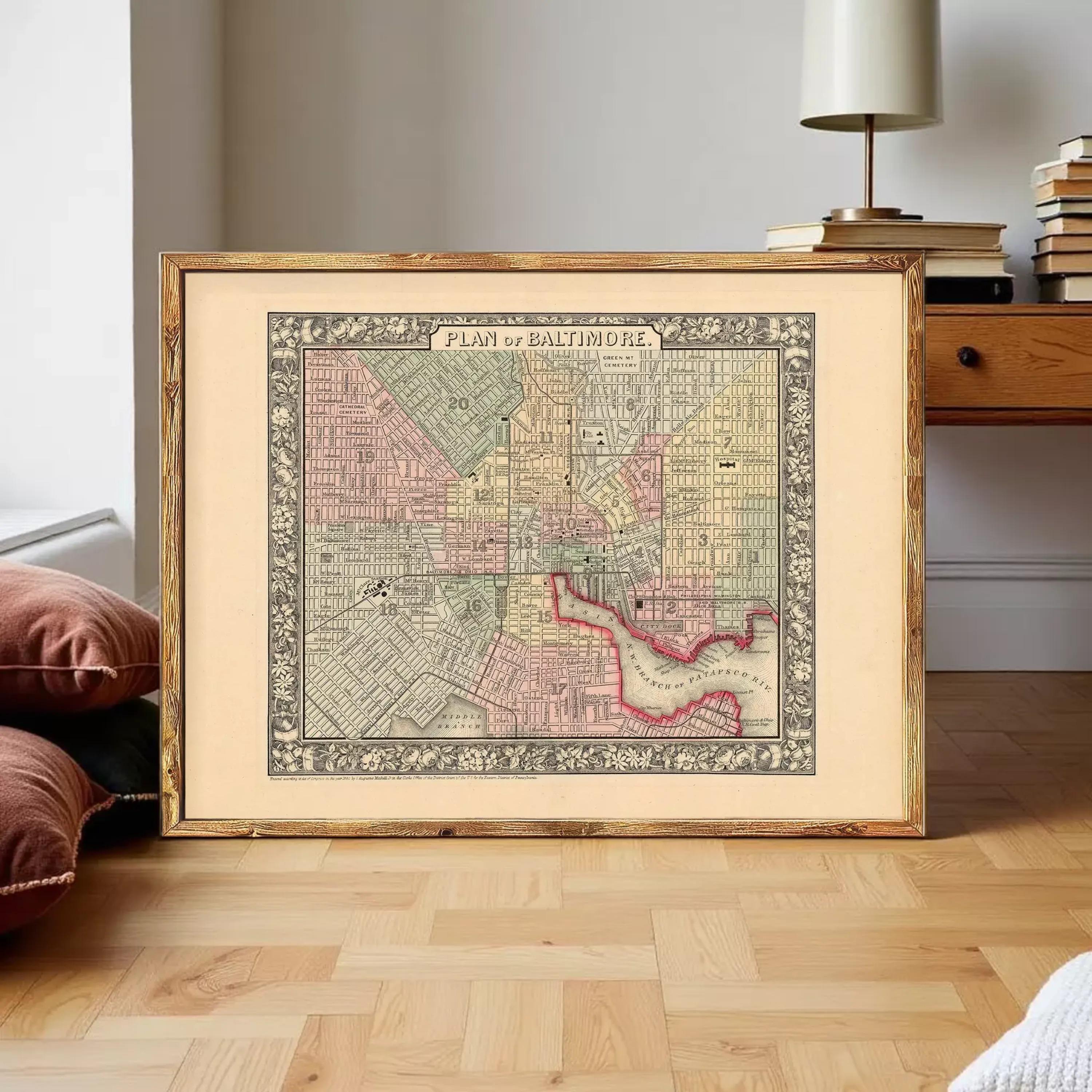 The image is a framed antique map of Baltimore, Maryland, depicting the city's streets and neighborhoods.