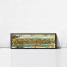 A framed vintage map of a mountainous region, featuring a detailed landscape with various geographical features and a body of water.