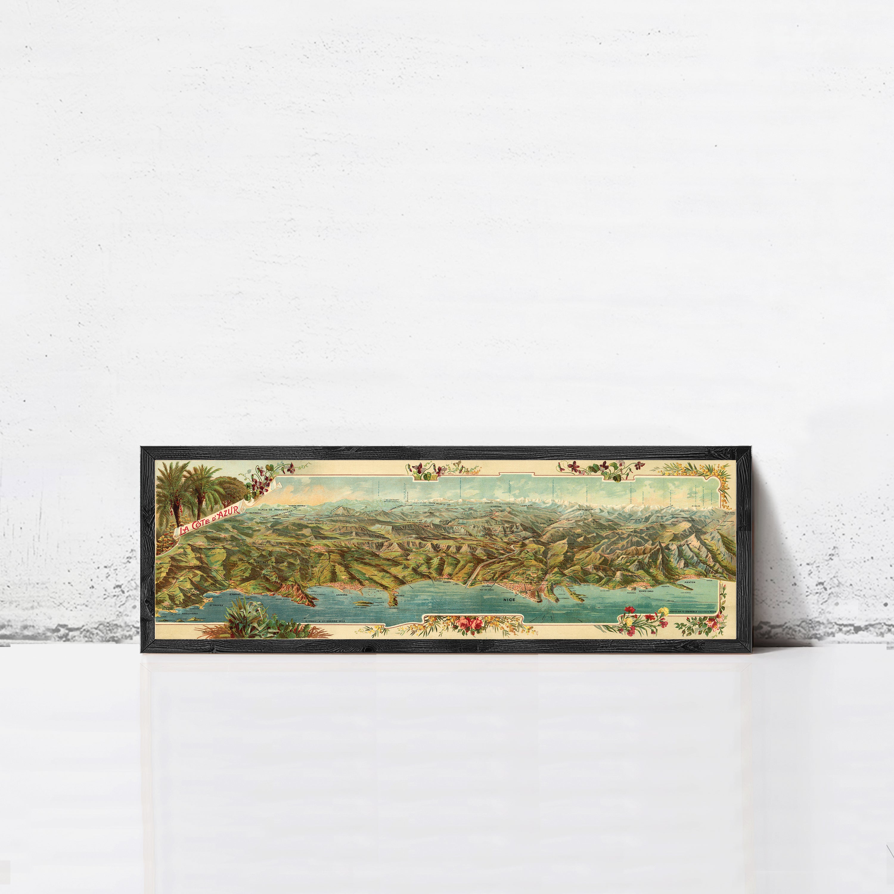 A framed vintage map of a mountainous region, featuring a detailed landscape with various geographical features and a body of water.