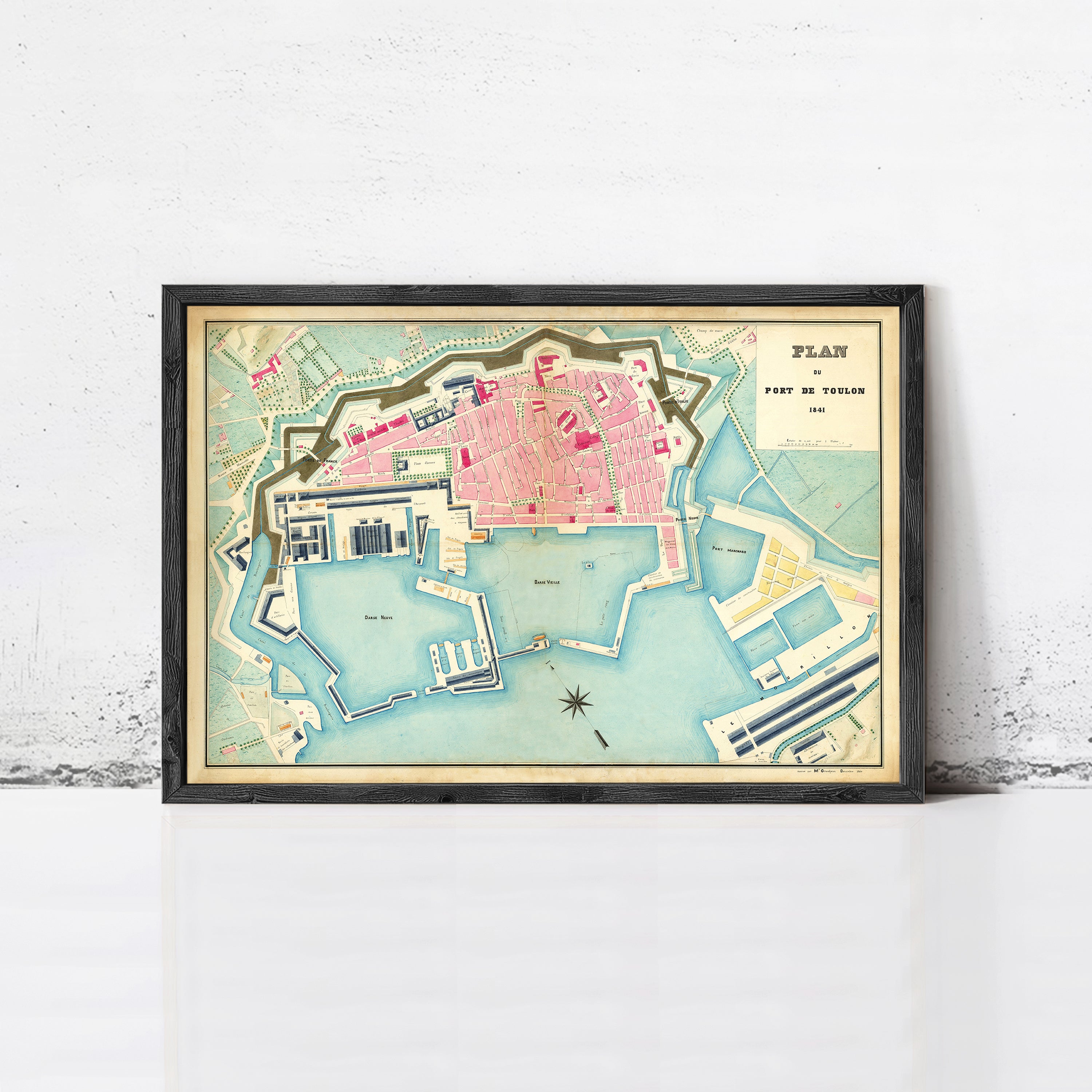 The image is a framed map of a city, likely a coastal city, with various landmarks and waterways depicted.