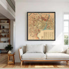 The image is a framed vintage map of a city, likely from the 19th century, with various landmarks and streets depicted in a detailed and colorful manner.