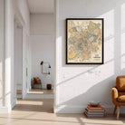a living room with a large framed map of Moscow hanging on the wall. The room has a white color scheme and includes a chair, a stack of books, and a bowl on the floor.