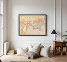 The image is a framed vintage map of a city, likely from the early 20th century, depicting the city's layout and surrounding areas.