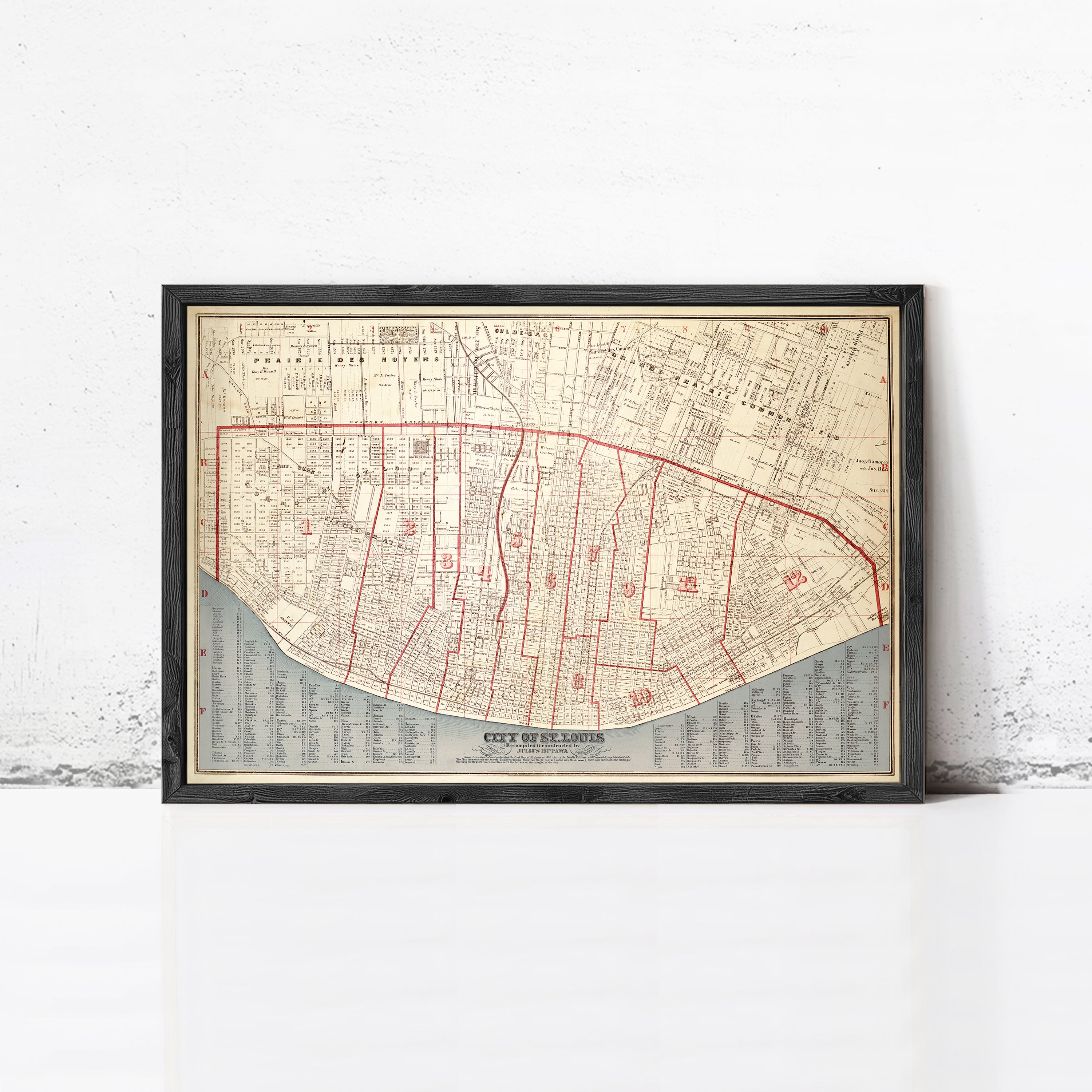 The image is a framed map of a city, likely New Orleans, with a detailed layout of streets, landmarks, and other geographical features.