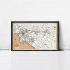 The image is a framed vintage map of Los Angeles, California, with a black border and a beige background.