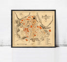 The image is a framed map of the city of Pamplona, Spain, depicting the layout and various landmarks within the city.