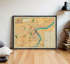 The image is a framed vintage map of a city, likely from the early 20th century, with a focus on the urban layout and surrounding areas.
