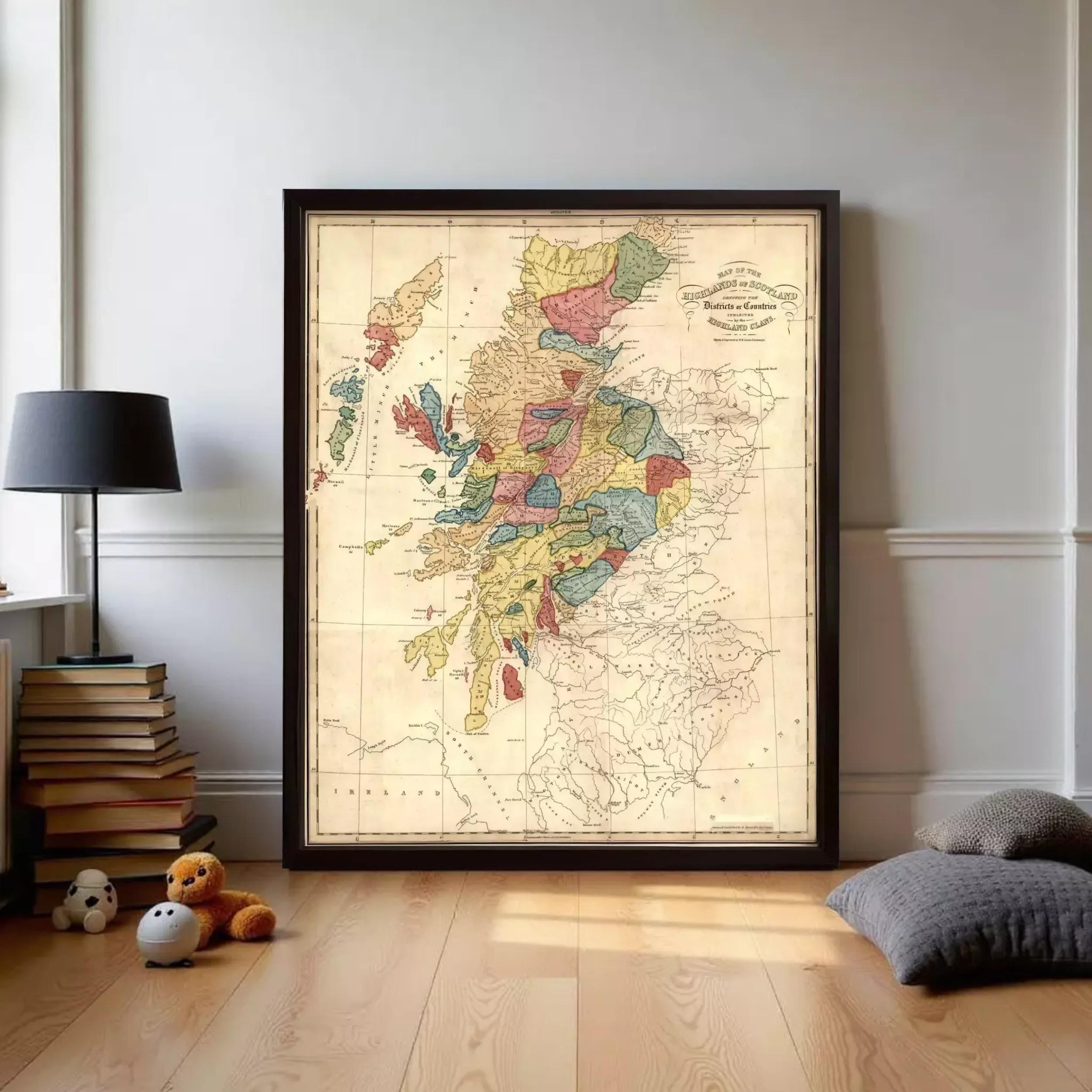 a large framed map of Scotland, with a black frame and a wooden floor in the foreground. There are also some books and stuffed animals in the background.
