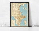 The image is a framed vintage map of a city, likely from the 19th century, displayed on a wall.
