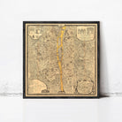 The image is a framed vintage map of a city, depicting a detailed layout of streets, buildings, and other urban features.