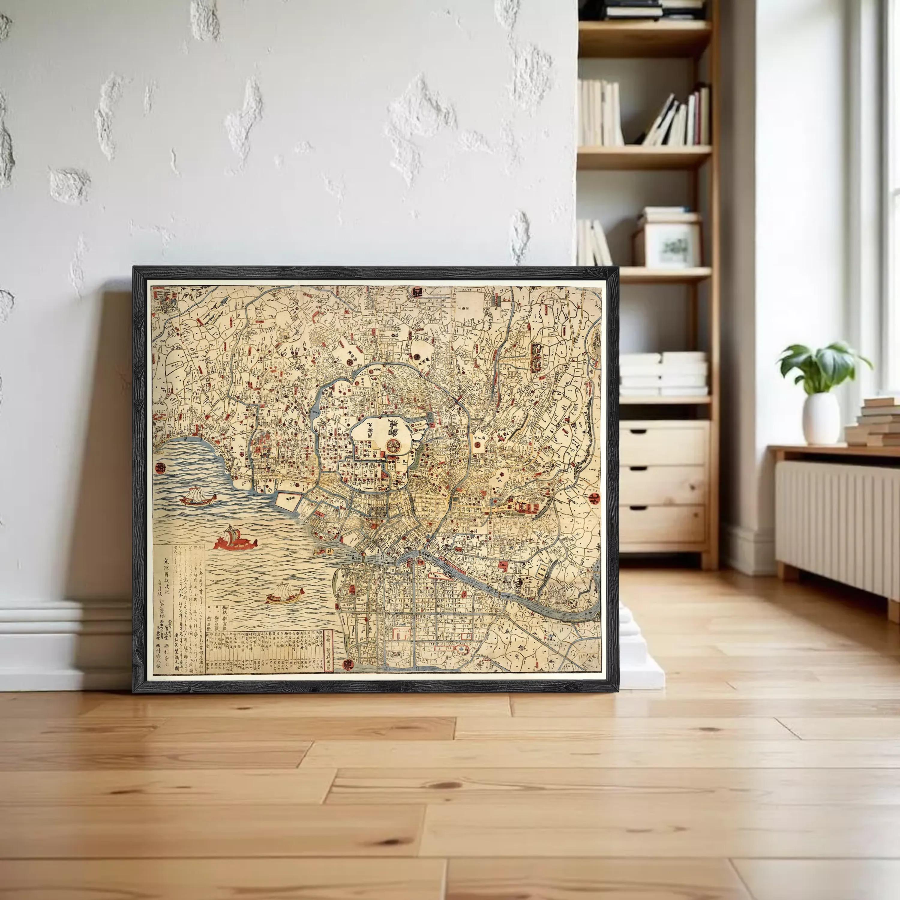 a framed map of a city, with a wooden floor and a bookshelf in the background.