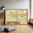 a large framed map of London, England, with a cityscape visible in the background.