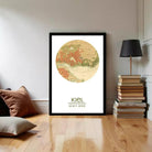 A framed map of Kiel, a city in Germany, is displayed on a wall in a living room setting.