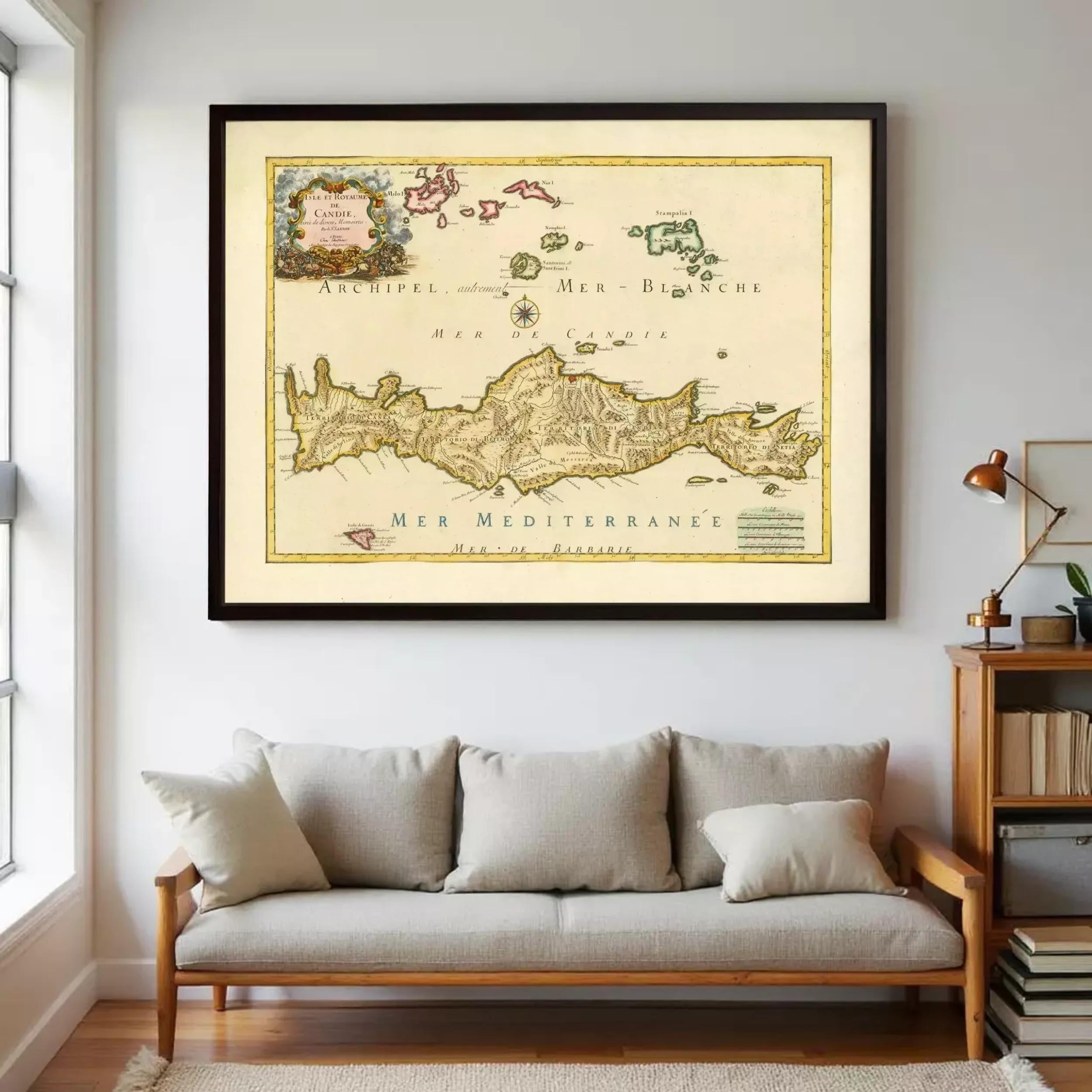 a large framed map of the Mediterranean region hanging on a wall above a couch in a living room.