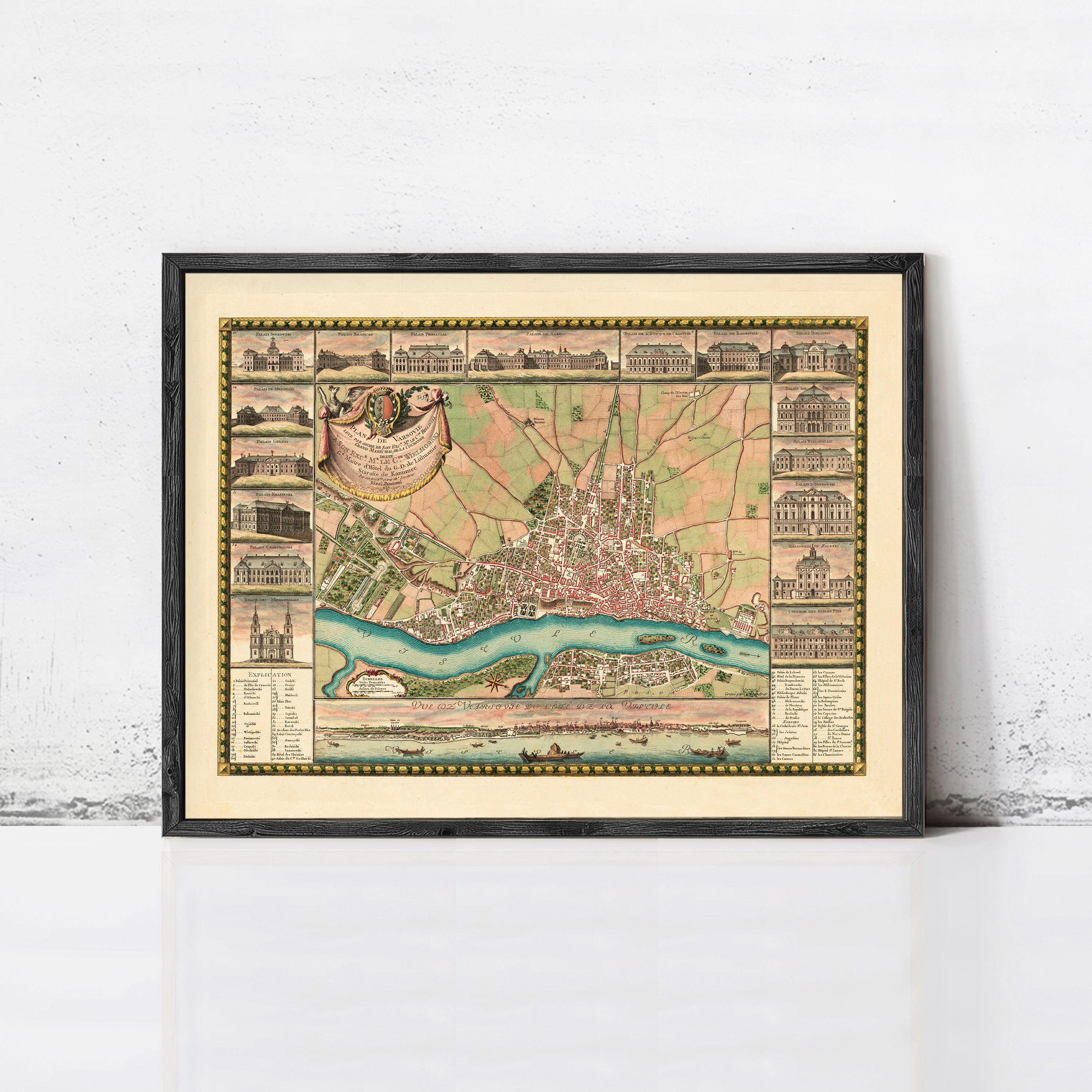The image is a framed vintage map of a city, depicting various landmarks and buildings in a detailed and intricate manner.