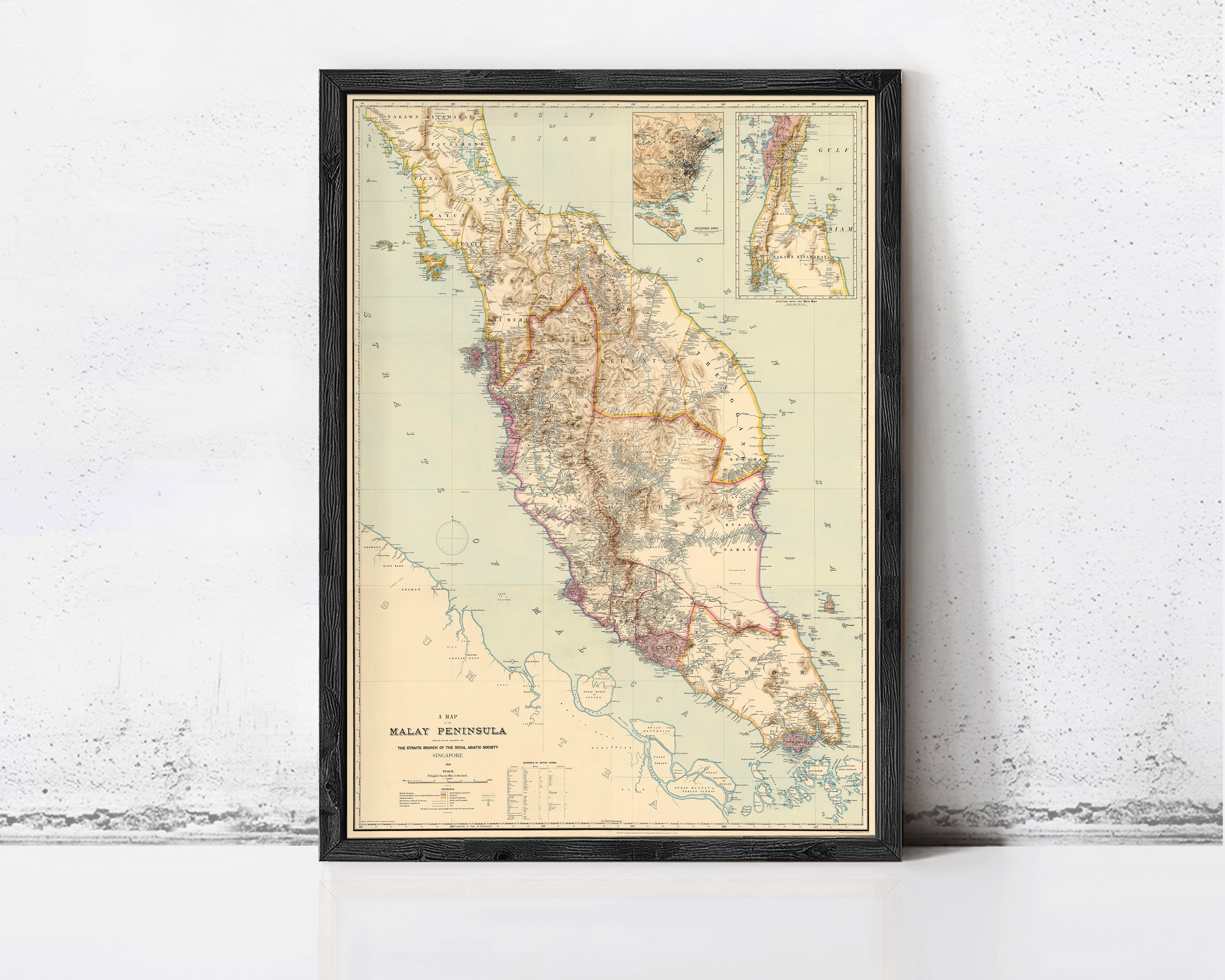 A framed map of Malaysia pinned to a wall.