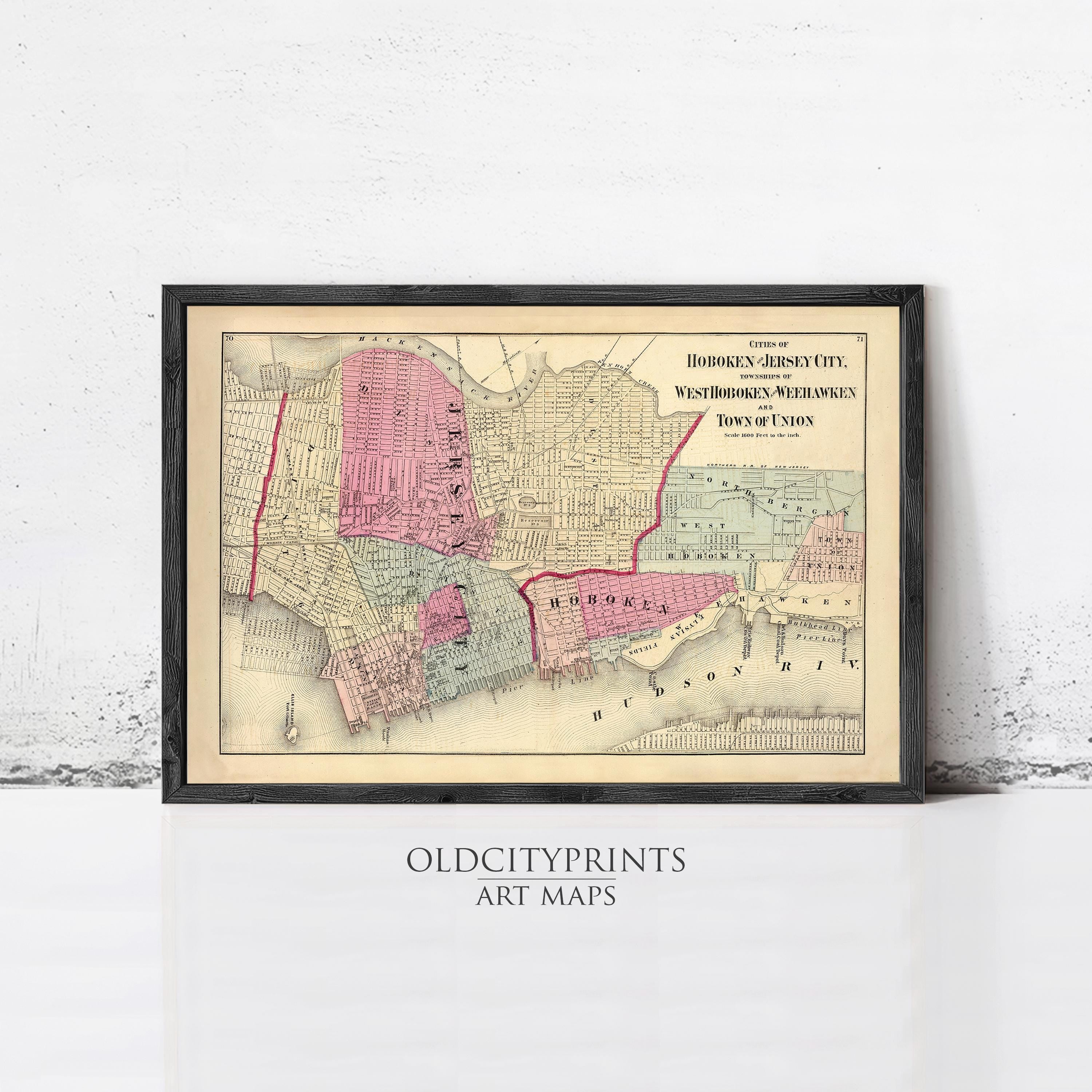 The image is a framed vintage map of Hoboken, Jersey City, New Jersey, depicting the city's layout and surrounding areas.