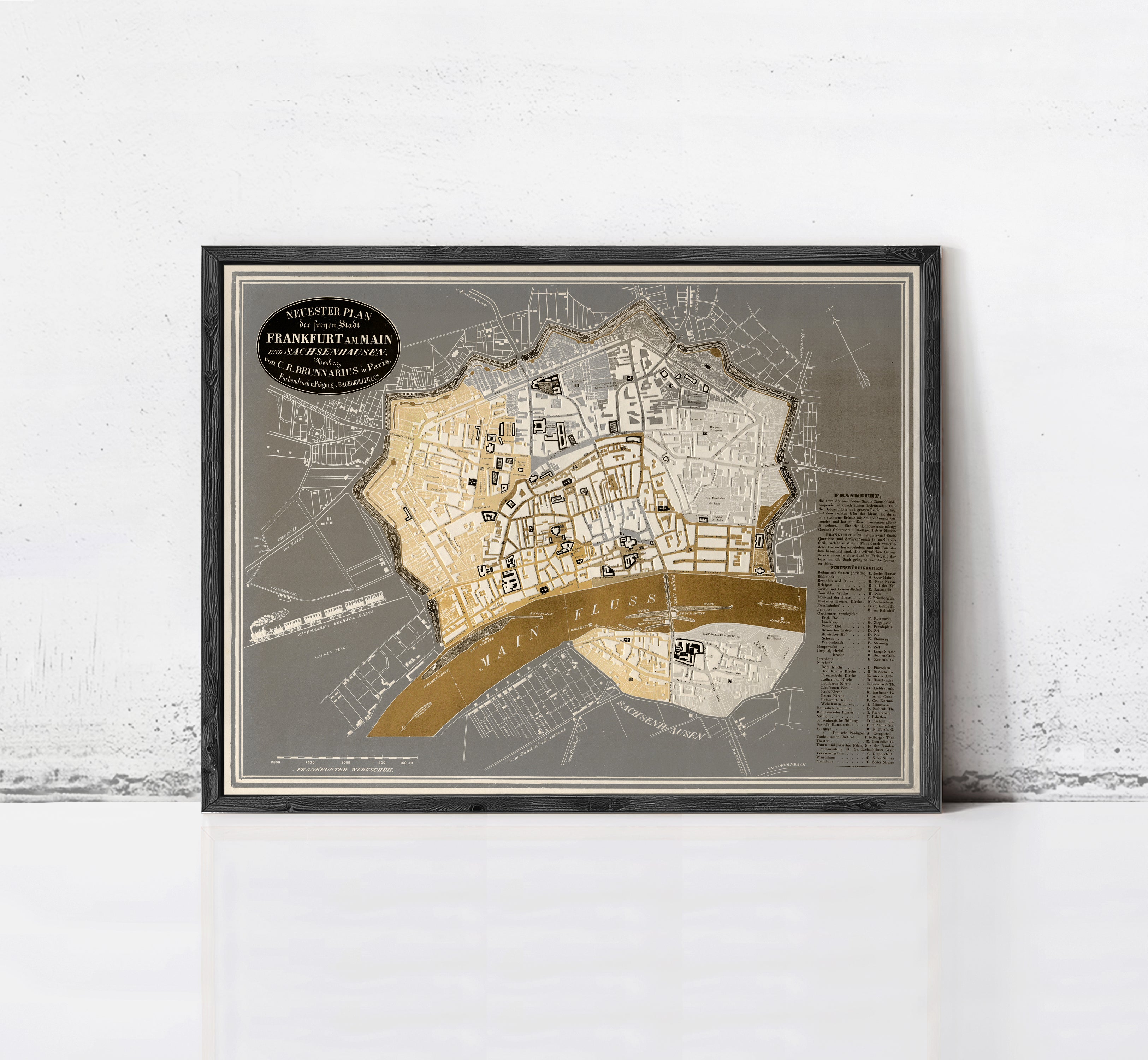 The image is a framed map of a city, likely a vintage or historical map, displayed on a wall.