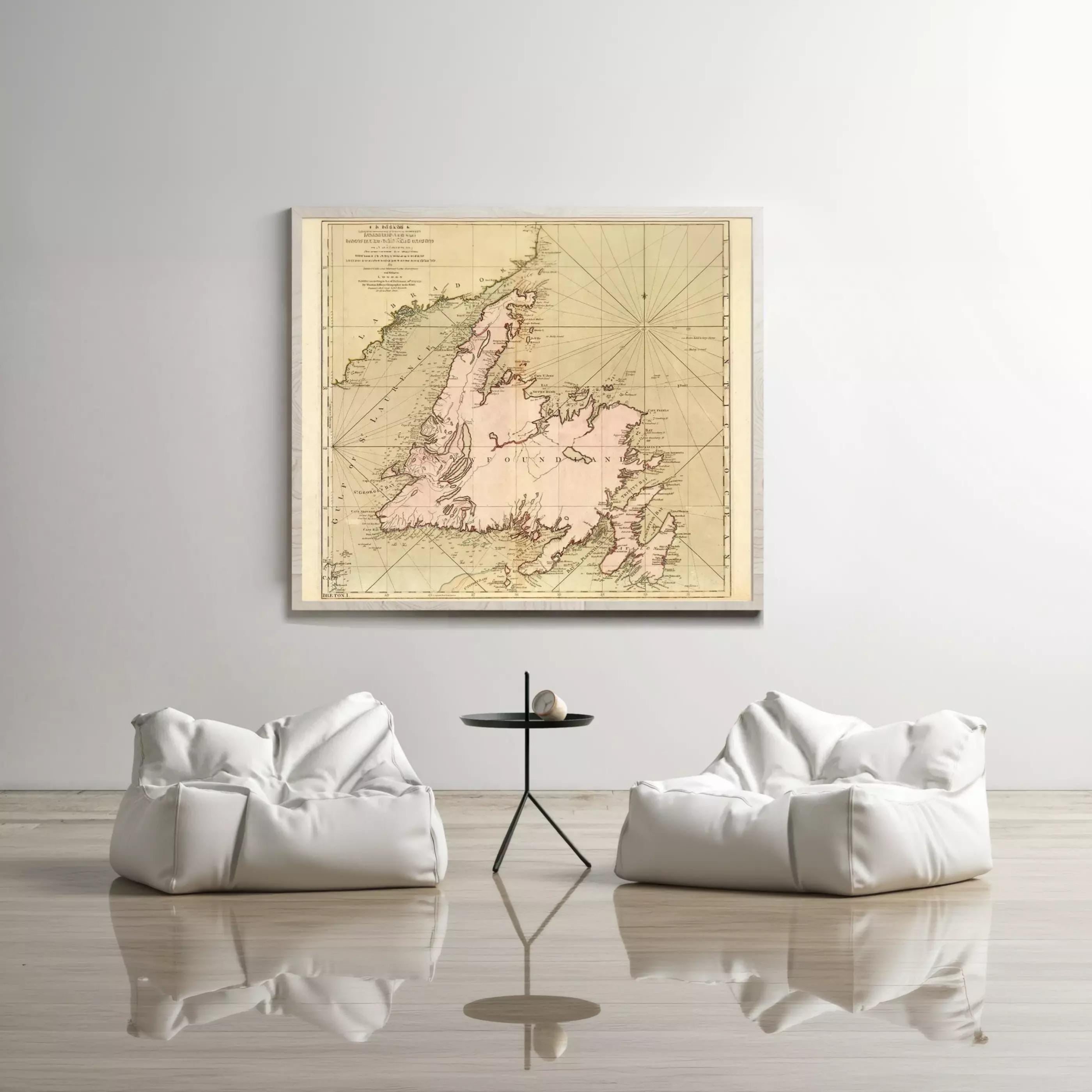a large map of Canada hanging on a white wall, with two white bean bag chairs positioned in front of it.