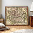 The image is a framed vintage map of a city, likely from the 17th century, depicting a detailed layout of the city with streets, buildings, and other landmarks.