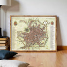 The image is a framed map of Milan, Italy, depicting the city's layout and streets.