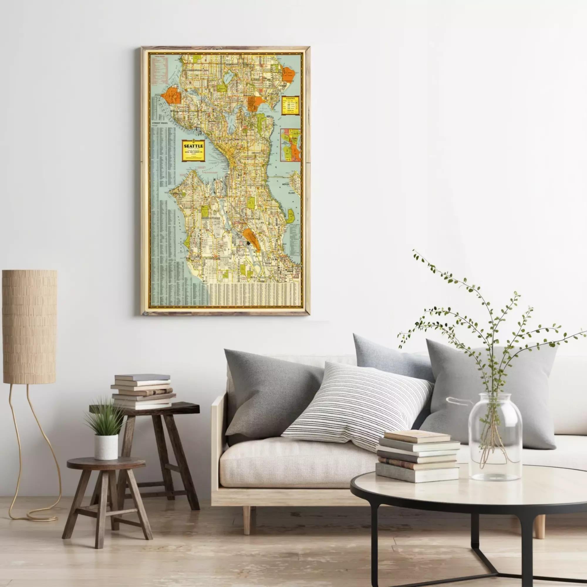 a framed map of Seattle, Washington, hanging on a wall above a couch with pillows.