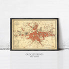 The image is a framed vintage map of a city, likely from the 19th century, with a red and beige color scheme.