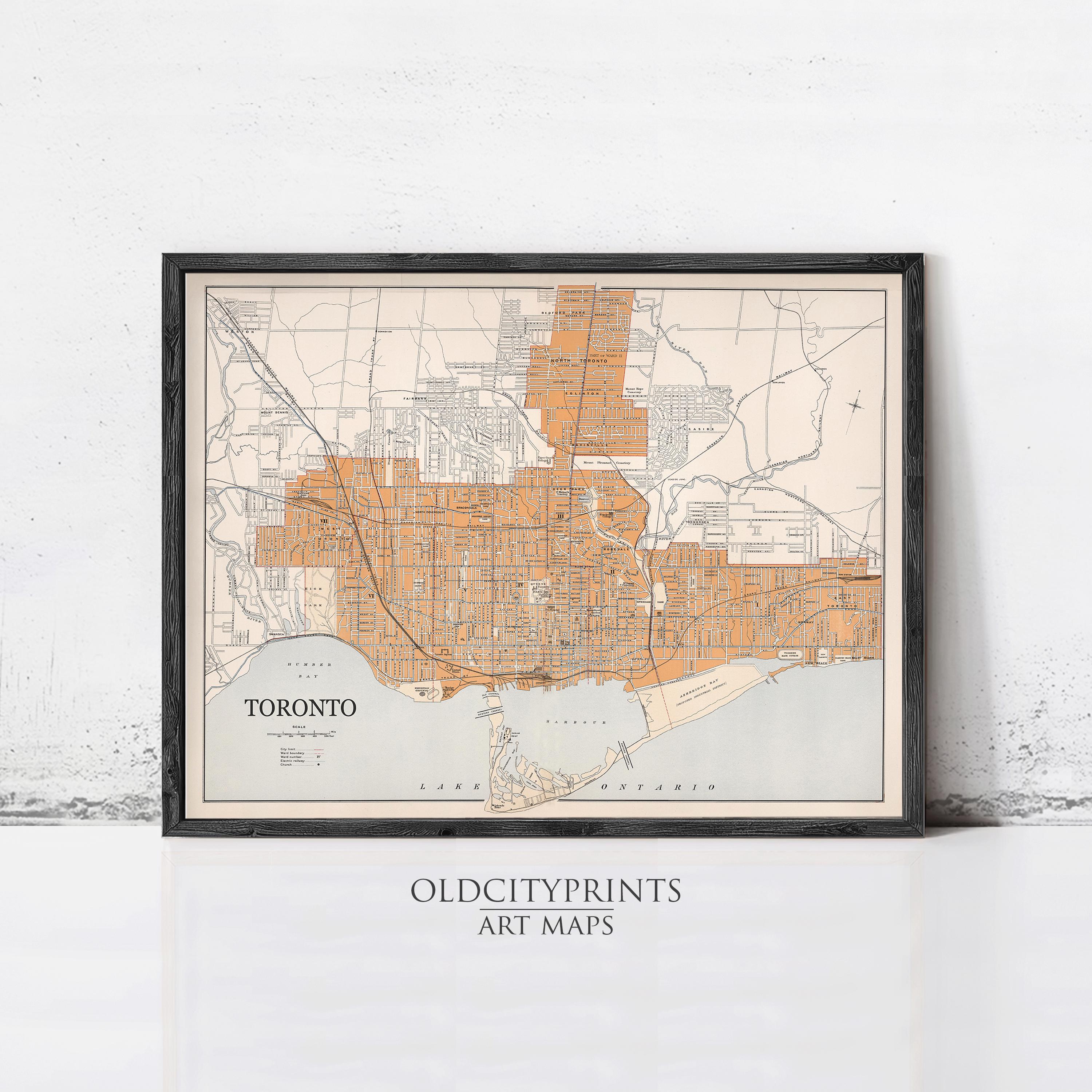 The image is a framed vintage map of Toronto, Canada, depicting the city's streets and surrounding areas.